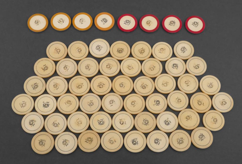 Assorted carved poker chips arranged in rows on a dark background, with small animal and floral-like motifs on their circular faces.