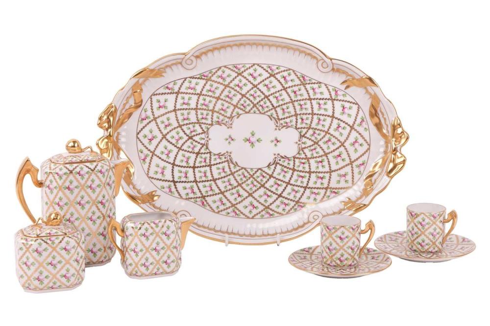 A Herend porcelain 'Sprog' coffee service on tray, enamelled with a rose and trellis deisgn within gilt borders, comprising a coffee pot, (15 cm high), two coffee cans and saucers, a milk jug and a covered sugar bowl, blue printed and painted... sold by Dawsons Auctioneers, lot 276 — auction record photograph