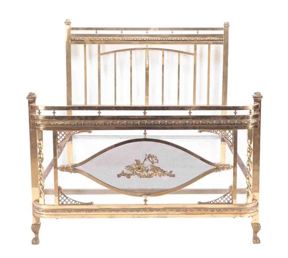 Gold brass metal bed frame with vertical spindles and decorative rails, front view with inset upholstered panel.