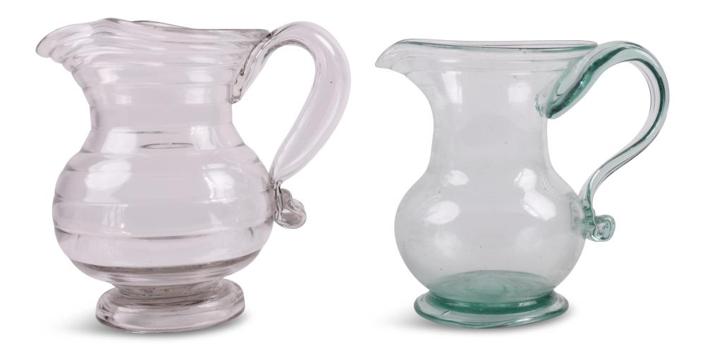 TWO AMERICAN FREE-BLOWN GLASS JUGS, MID-19TH CENTURY Heights: 7 in. (17.8 cm.) and 6 1/4 in. (15.9 cm.) sold by Potomack Company, lot 4192 — auction record photograph