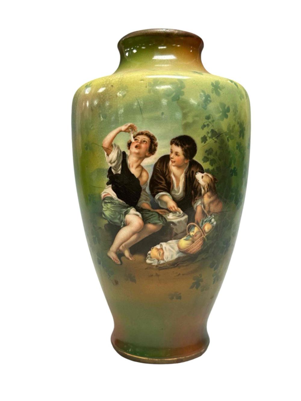 Green ceramic vase with painted figures and a dog, decorated with clover-like patterns and a wide neck.
