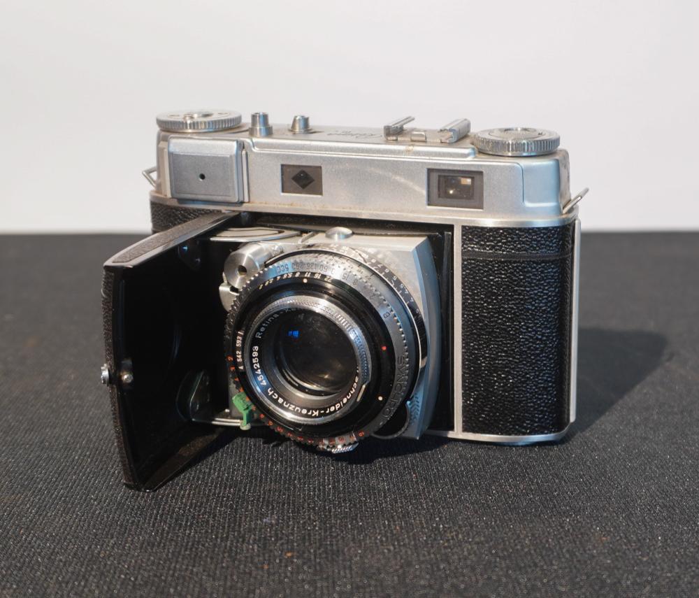 Vintage Kodak Retina III rangefinder camera with a black leather body and silver top, shown from the front-left with lens visible.