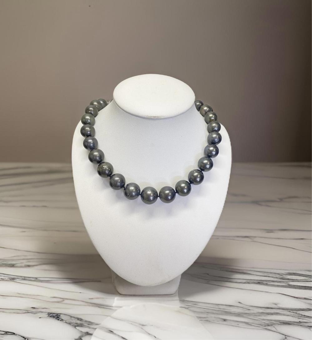 Tahitian Pearl and Diamond 14ct White Gold Necklace. Comes With a Certificate of Valuation of $12,890. Thirty Three Cultured Tahitian Near Round Pearls. Clasp Features Four Round Brilliant Cut Diamonds. Necklace Measu... sold by Pottle Auctions, lot 190 — auction record photograph