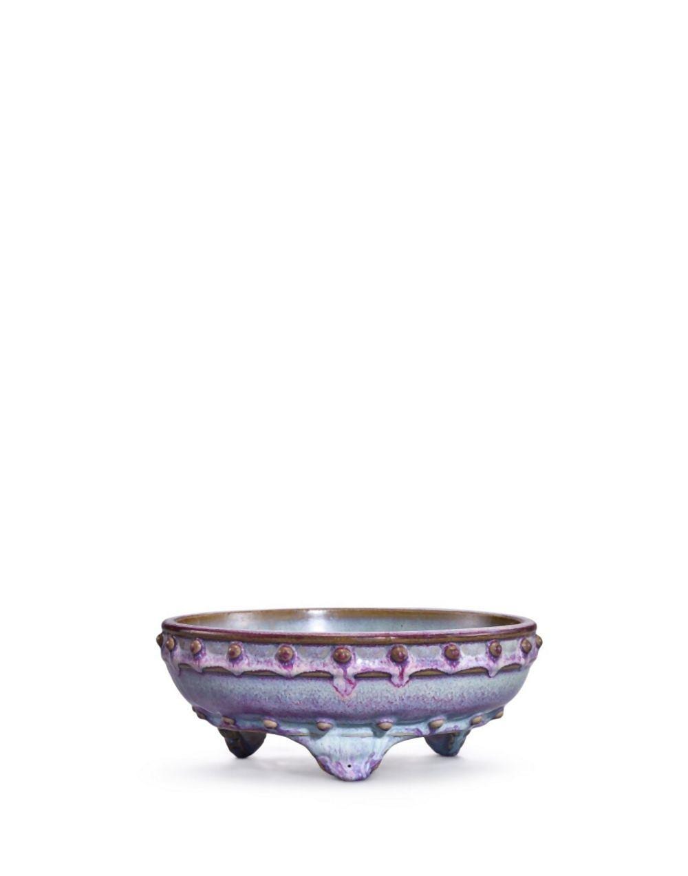 A Junyao purple and blue-glazed tripod narcissus bowl, Ming dynasty | 明 鈞窰紫釉鼓釘三足水仙盆 底刻「五」及「八」字、一足內刻「八」字 comparable sale