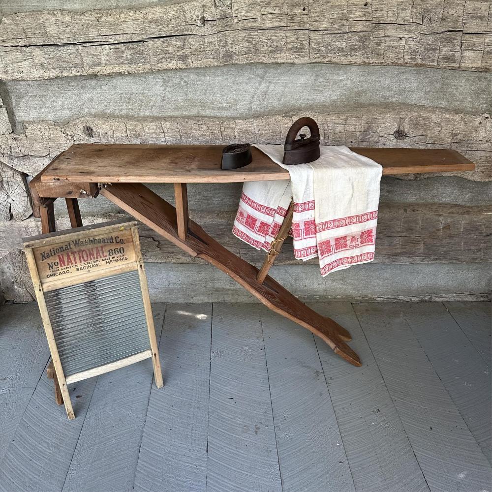 Wooden Ironing Board with National Washboard & Sad Irons, 52 x 18 1/2 x 30 1/2 in. (132.1 x 47 x 77.5 cm.) ironing board, 12 1/2 x 24 in. (31.8 x 61 cm.) washboard sold by Asselmeier May Auctions, lot 71 — auction record photograph
