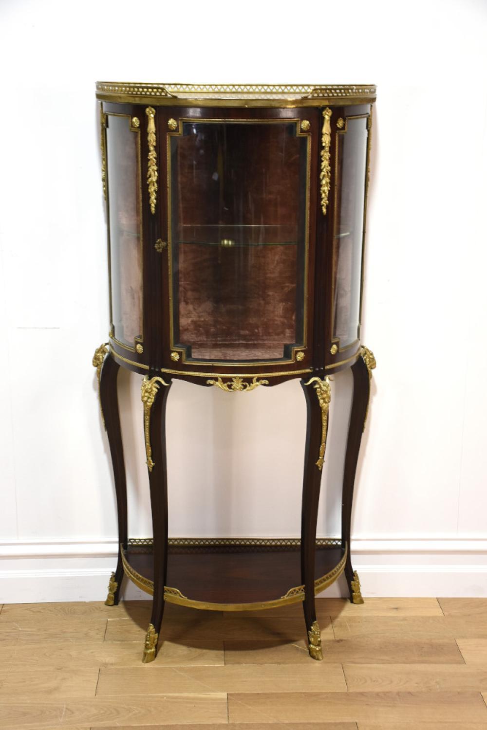 A fine quality French 19th century bow front vitrine having fine ormolu mounts and marble top. sold by E J Ainger, lot 303 — auction record photograph