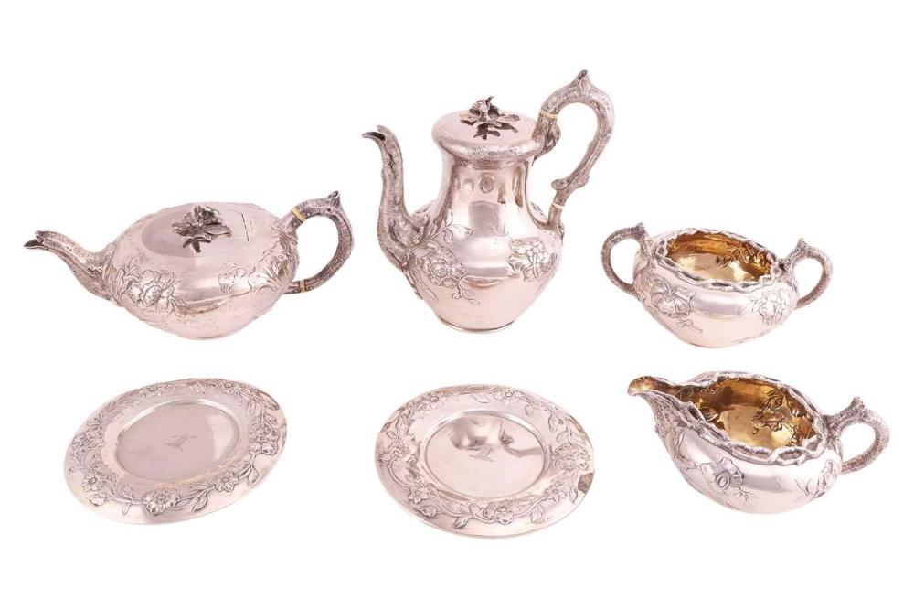 A William IV four-piece silver tea service, the teapot and coffee pot with bird and flower cast finials, the bark handles with ivory insulators, with overall chased decoration with large flower scrolls, each with wooden filled teapot stands, the... sold by Dawsons Auctioneers, lot 296 — auction record photograph
