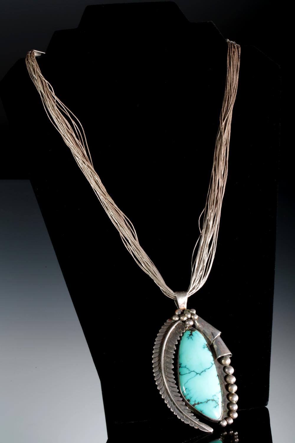 Auction comp thumbnail for Vintage Navajo Sterling Silver & Turquoise Pendant with Liquid Silver Necklace Native American Jewelry (Ace Of Estates, Lot 923246)
