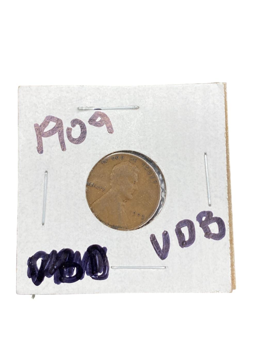 A copper coin lies on a white paper card with handwritten “1919” and “VDB,” plus handwritten size marks.