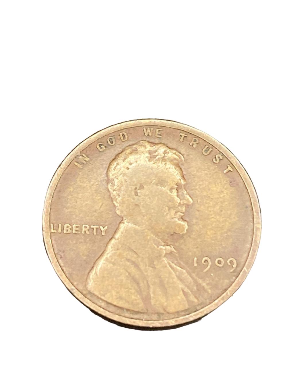 Close-up of a Lincoln Wheat penny showing “LIBERTY,” the portrait of Abraham Lincoln, and the date “1909.”
