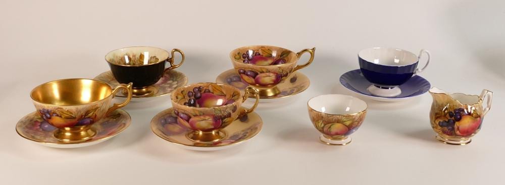 Aynsley, five Aynsley Orchard Gold tea cups and a small milk jug and open sugar bowl. Signed D. Jones and N. Brunt (7) sold by Potteries Auctions, lot 911 — auction record photograph