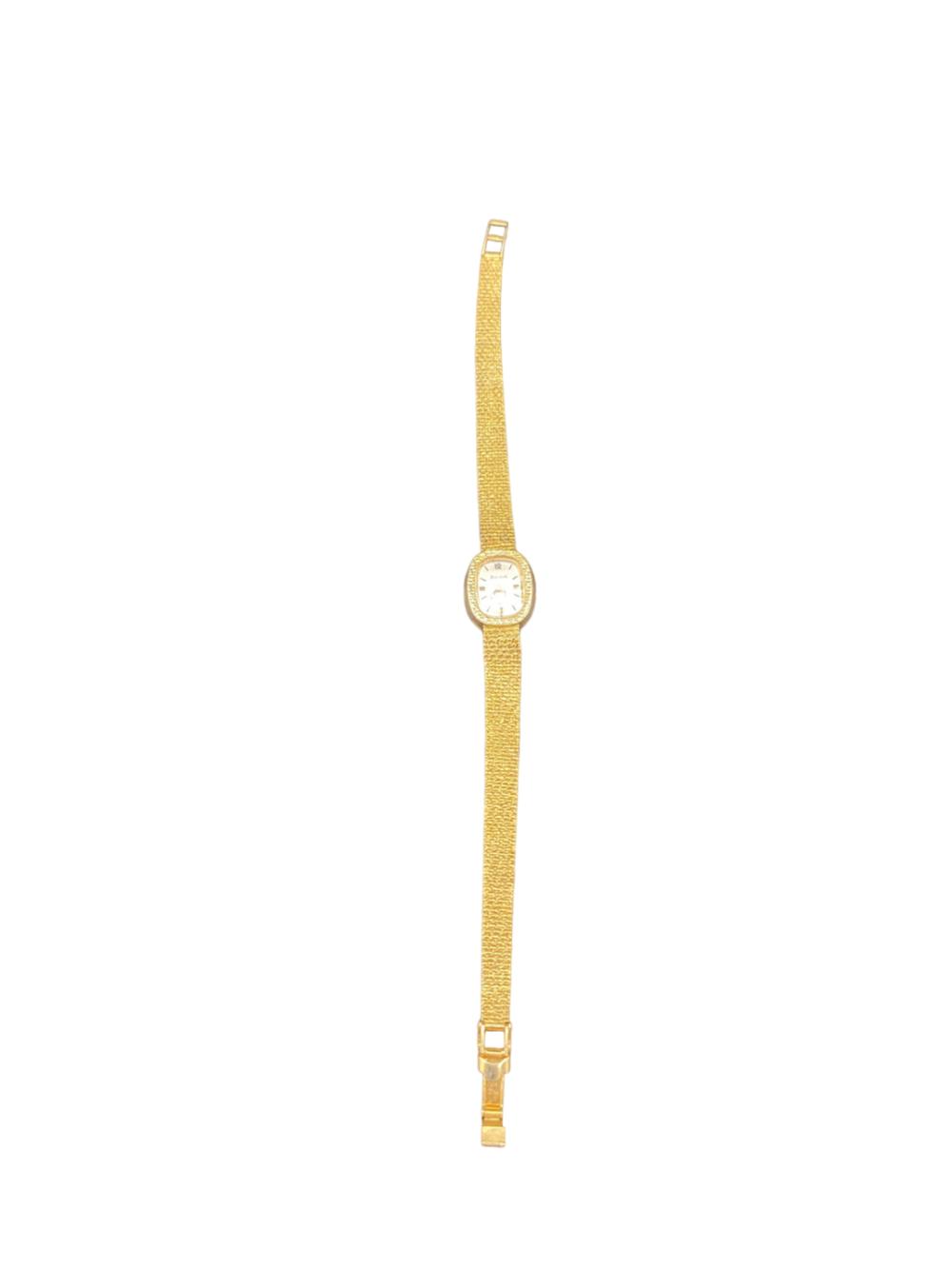 Gold-tone wristwatch with a round dial on a textured metal bracelet, shown against a white background.