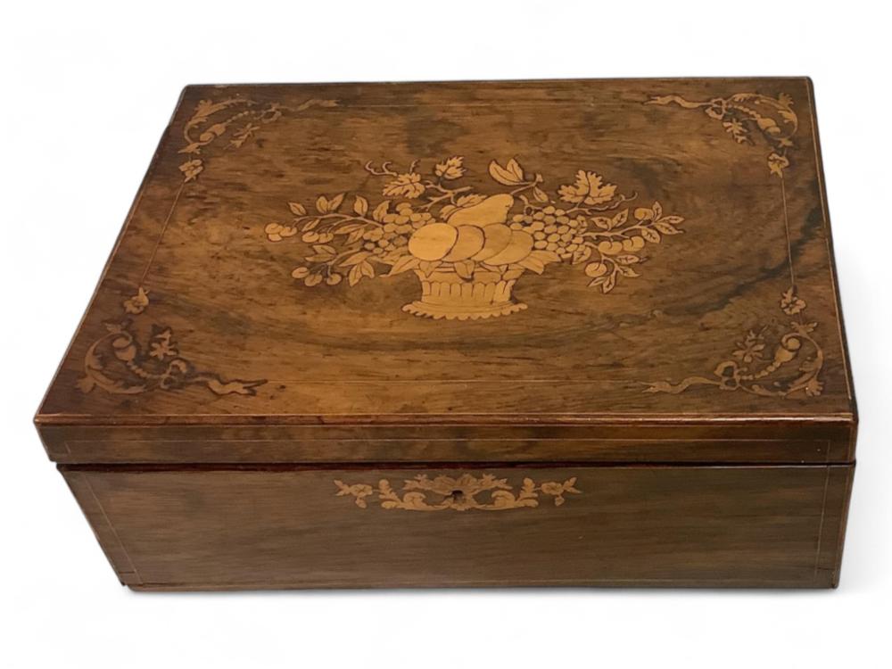 Brown wooden sewing box with a floral urn design on the lid and decorative floral banding along the front.