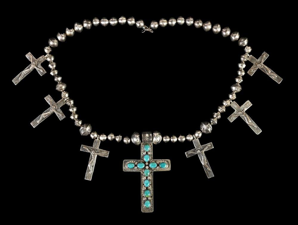Sterling silver beaded necklace with multiple cross charms and a central cross pendant with turquoise-colored stones.
