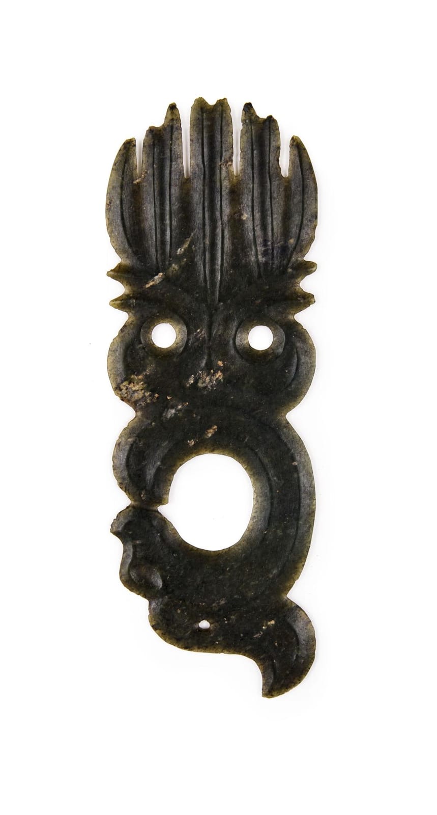 Dark stone or jade amulet pendant with a pointed fan-like top, two circular holes, and a rounded ring-shaped opening.