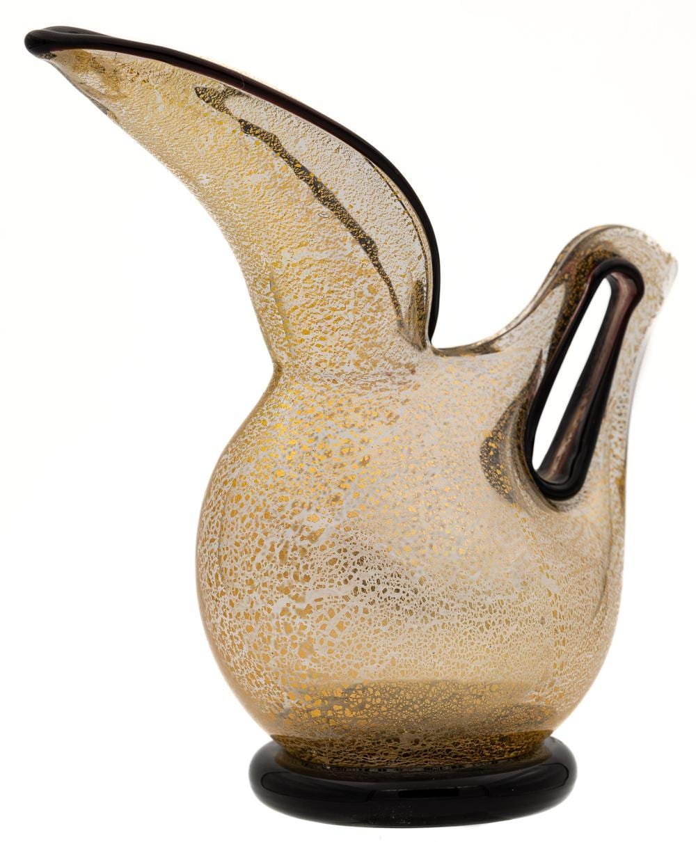Handheld glass pitcher with a dark spout and handle, featuring a speckled amber-gold surface and a thin darker stripe near the rim.