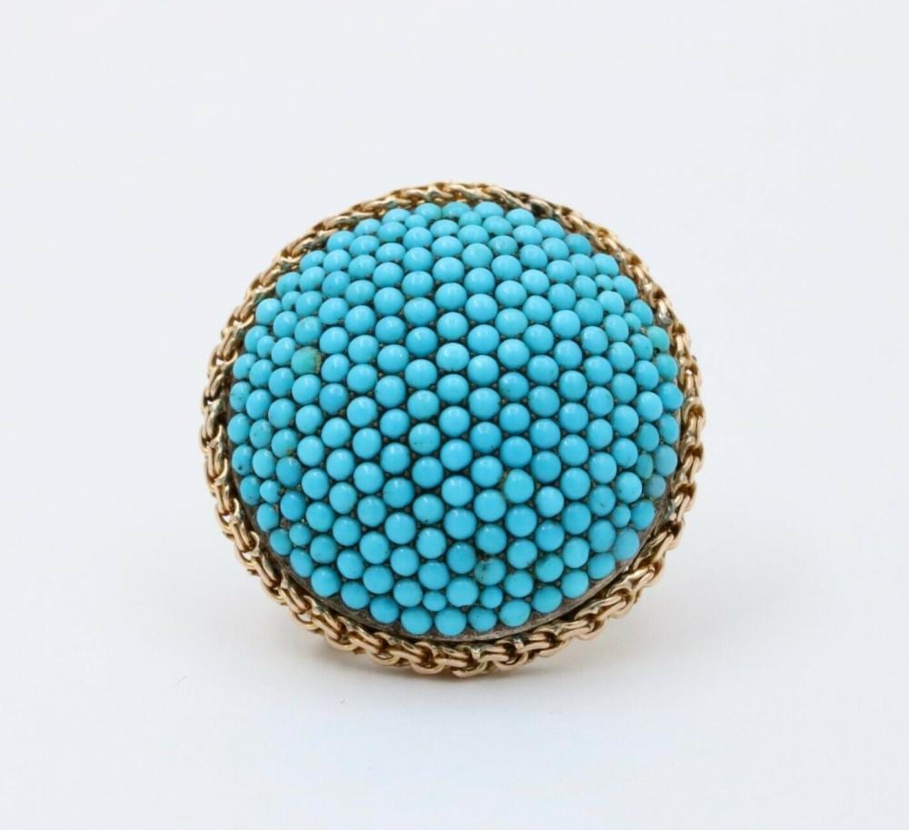 Round turquoise dome brooch with rows of small blue stones and a gold-toned rope border.
