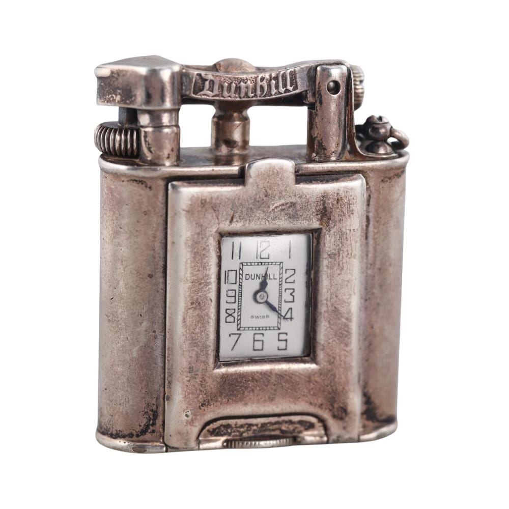 Vintage metal lift-arm watch lighter with a rectangular face displaying the Dunhill logo and numbers, shown front view on a white background.