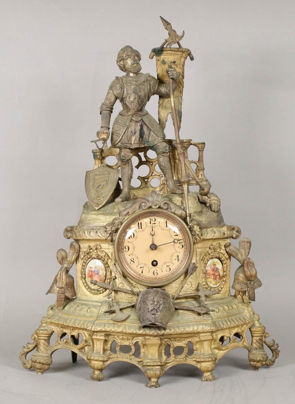 Ornate figural mantel clock with a soldier figure and gold-tone case, featuring an analog clock face with Roman numerals.