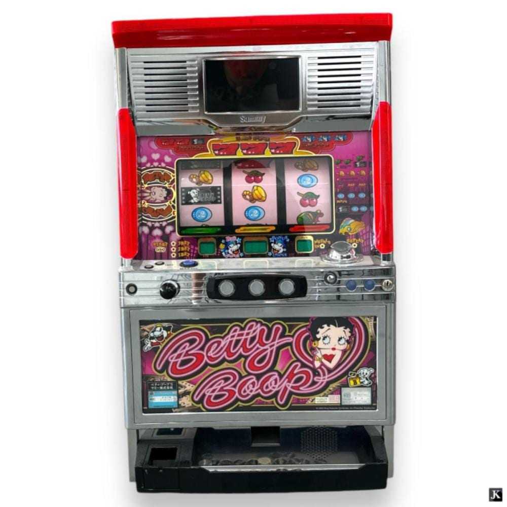 Front view of a red-and-silver slot machine with a video screen showing slot symbols and a Betty Boop panel.
