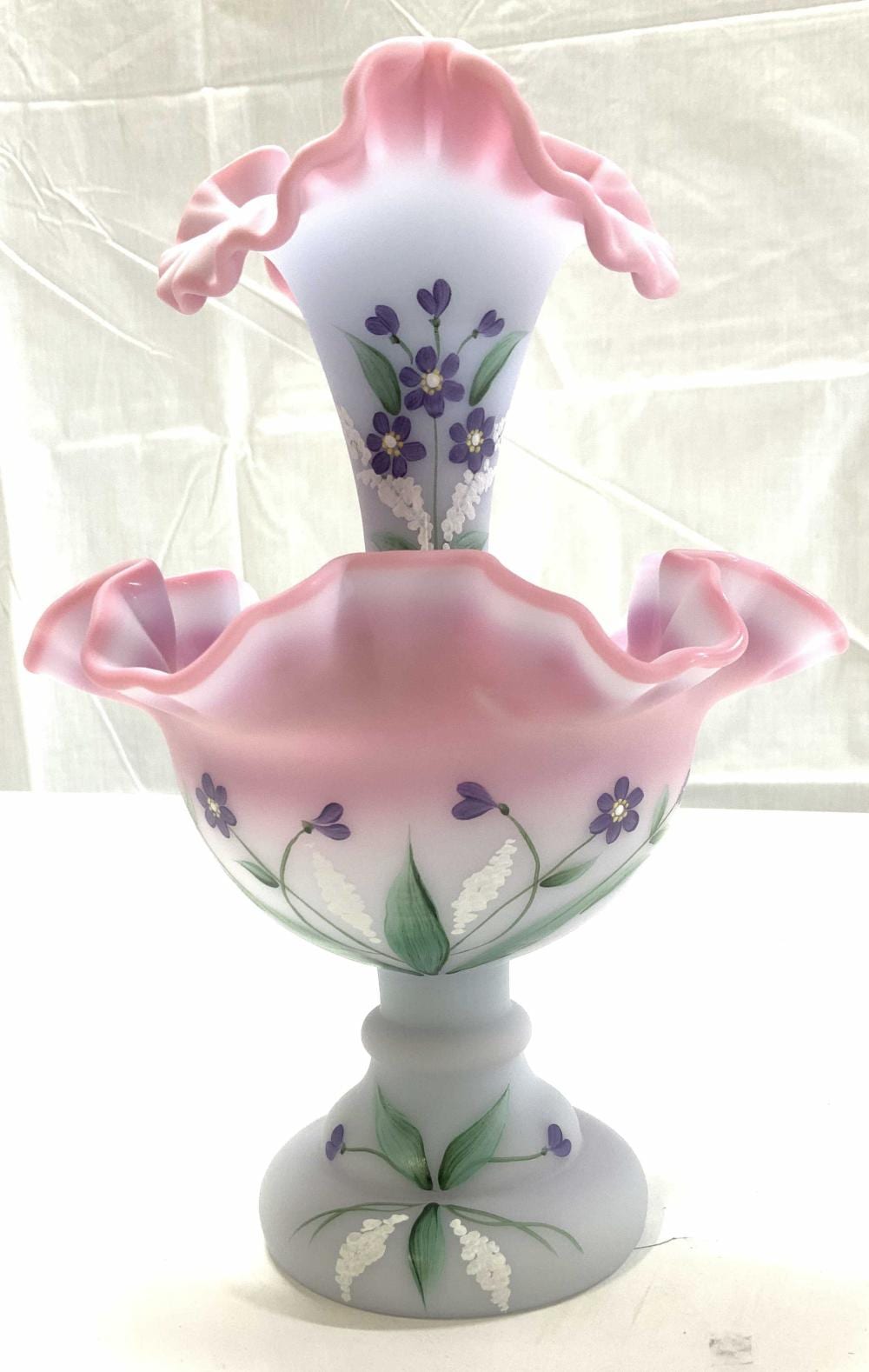 White art glass decorative vessel with pink ruffled rim and hand-painted purple and green wildflower designs.