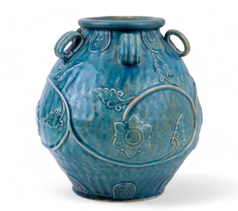 Blue ceramic jar with a rounded body, short neck, two side handles, and raised decorative floral scrollwork.