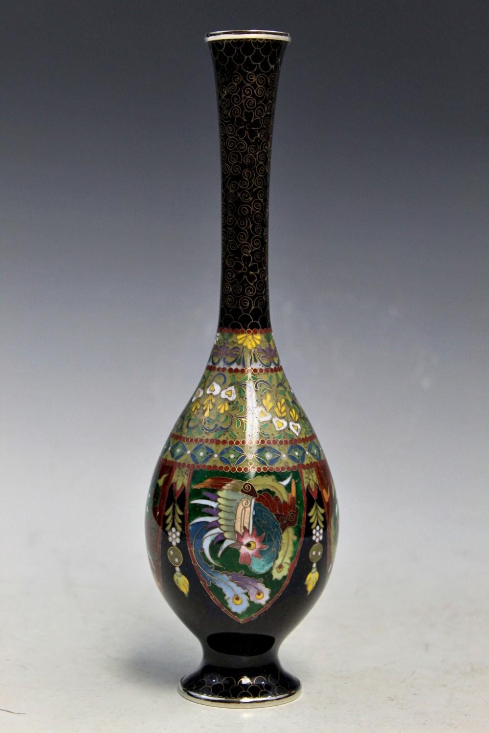 Tall black cloisonné vase with gold and swirling patterns, decorated with colorful birds and flowers on the body.
