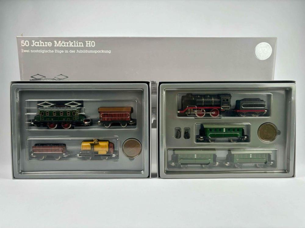 Boxed model train set with multiple HO-scale locomotives and freight cars arranged in clear plastic compartments.