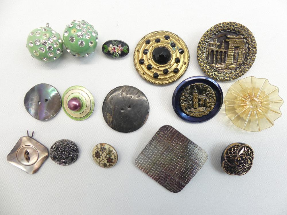 Assortment of vintage metal and decorative buttons, including round and floral designs with green, gold, blue, and dark finishes.