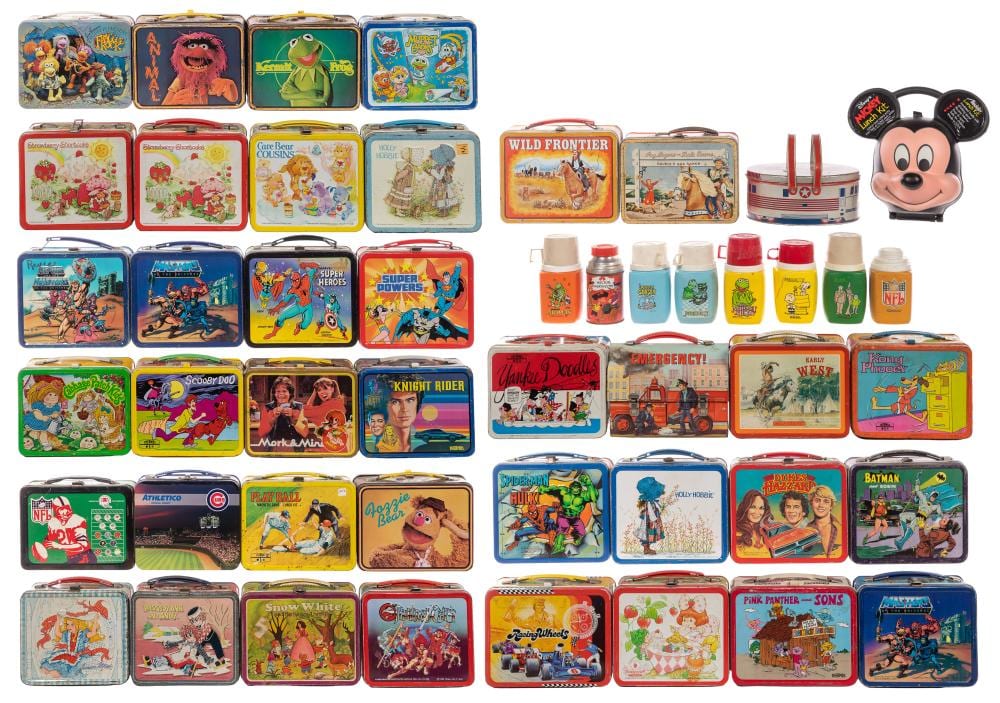 Assorted colorful metal lunch boxes with character and cartoon graphics, grouped together.