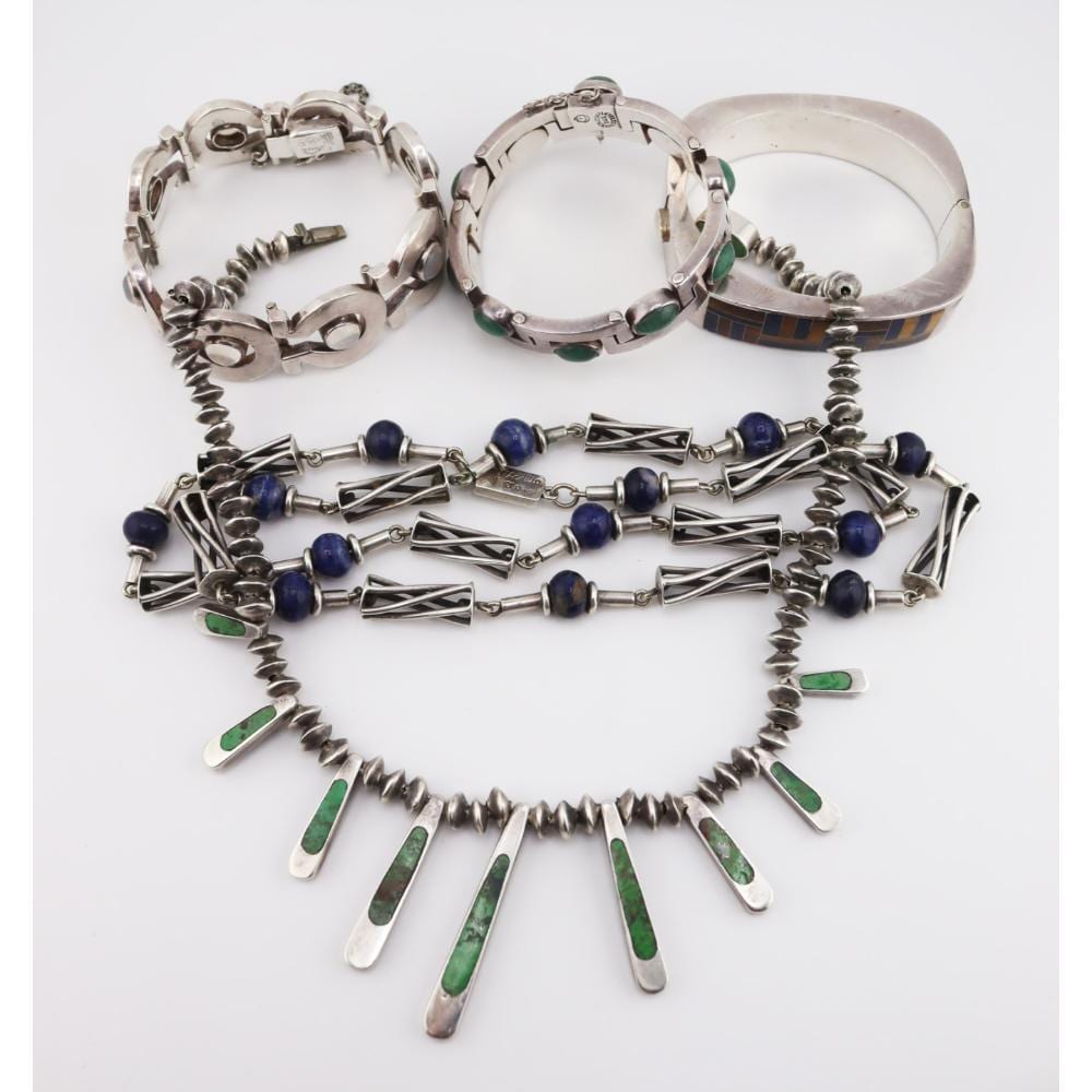 Set of silver-tone Mexican-style jewelry with blue bead cabochons, green enamel accents, and spiked fringe necklace with matching bracelets.