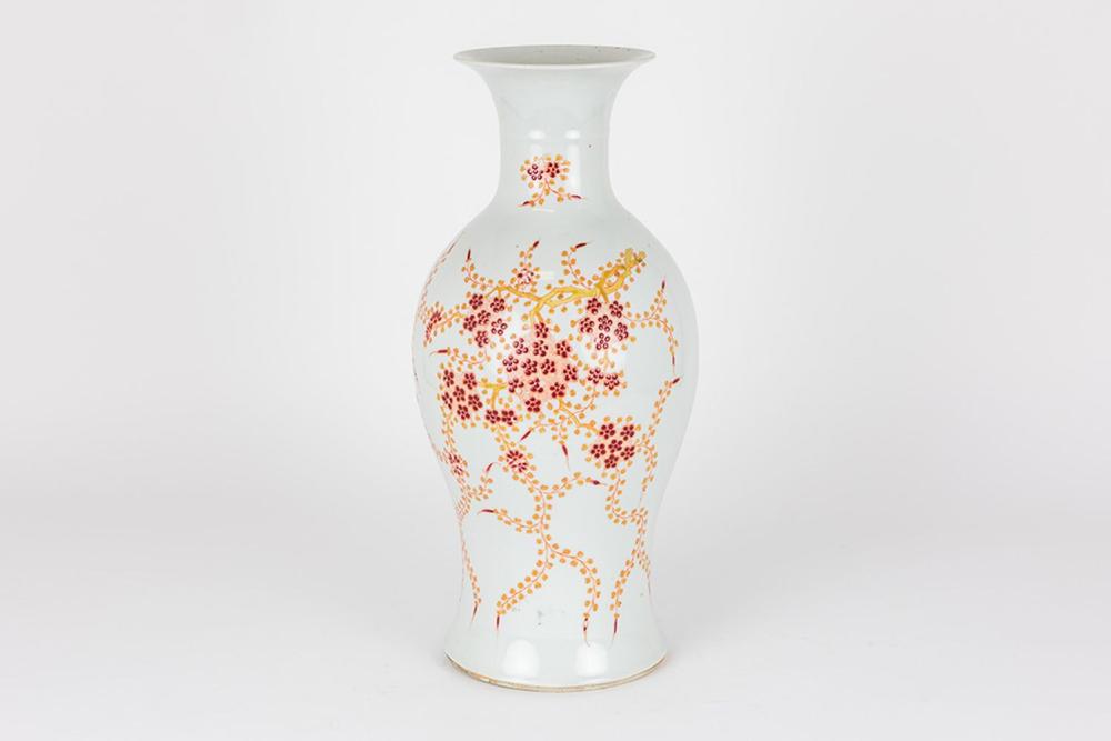 White ceramic vase with a narrow neck and flared rim, decorated with red and gold polychrome blossoms and branches.