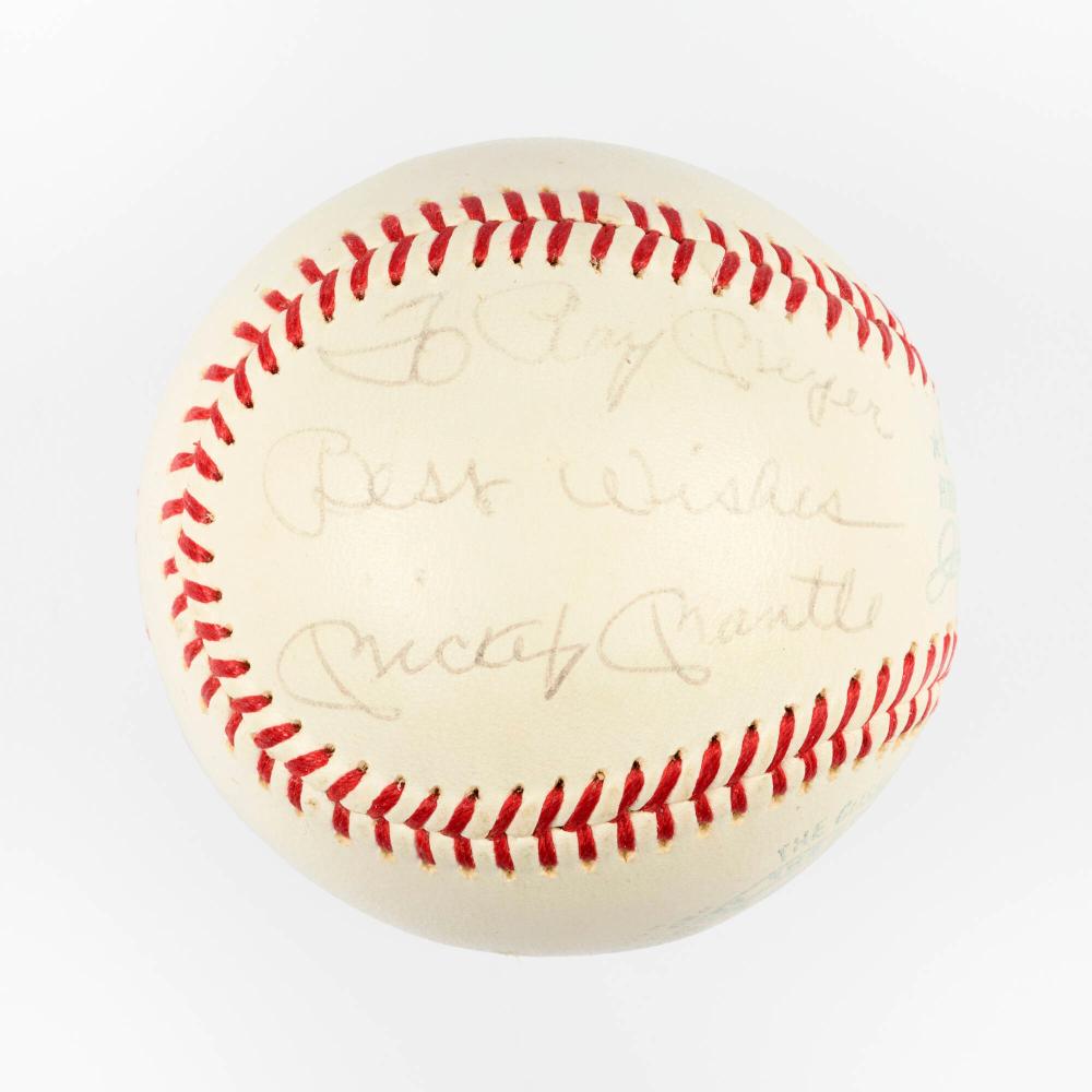 White baseball with red stitching around the edge and handwritten signature-style text on the surface.