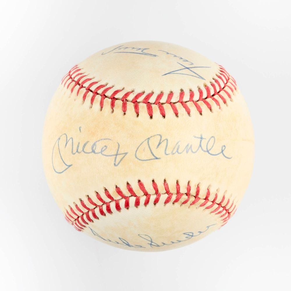Baseball with blue signatures and red stitching visible on a white background.