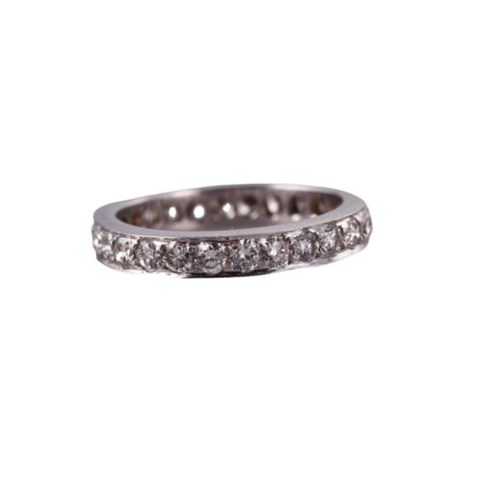 Silver-toned ring with a continuous row of small round diamonds along the band, photographed against a white background.