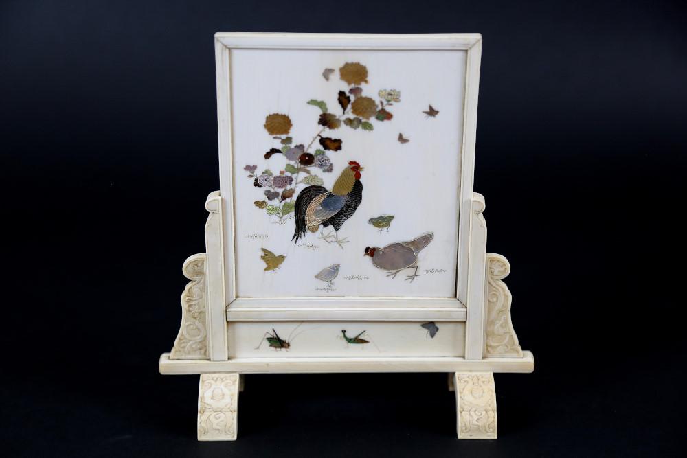 Auction comp thumbnail for An outstanding Japanese Meiji period ivory shibayama table screen having finely detailed mother of pearl inlay depicting the chickens and insect. Supported on a carved base having geometric decoration. H 21cm, W 20cm (Christian McCann Auctions, Lot 601)