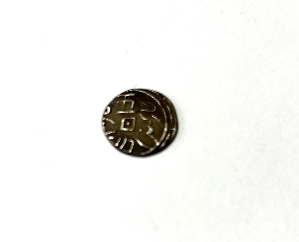 Small round silver coin with darkened border and central Chinese-style symbols, shown on a white background.
