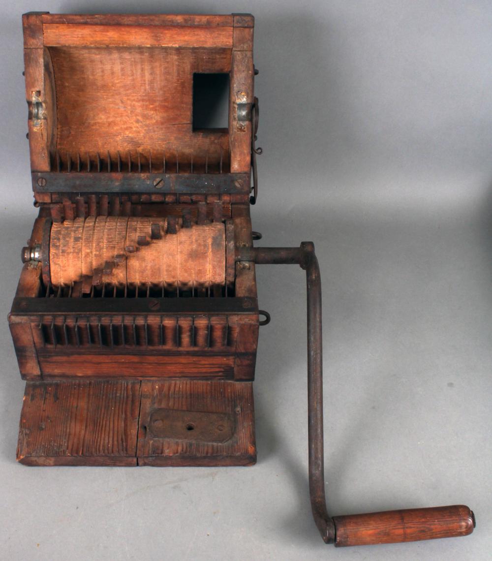 Antique wooden sausage/meat grinder: a very early oak case box-form grinder with wrought iron hardware with wooden roller; 11” W not including handle X 17” L on board not including handle (Good) Very original NO SHIPPING sold by Roan Inc. Auctioneers & Appraisers, lot 358 — auction record photograph