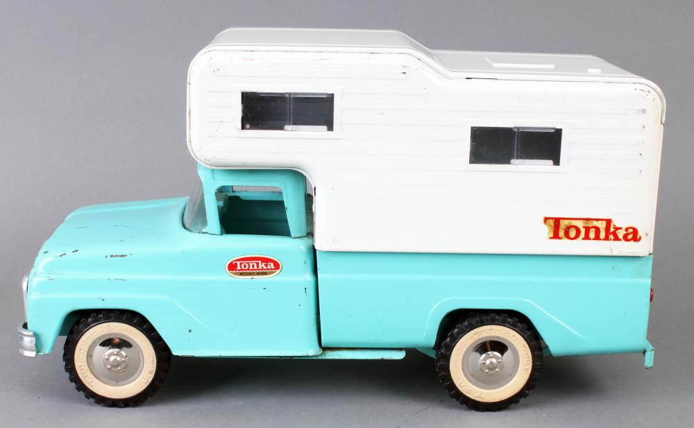 Turquoise and white Tonka toy camper truck with a white cargo trailer and black wheels, shown in side view.
