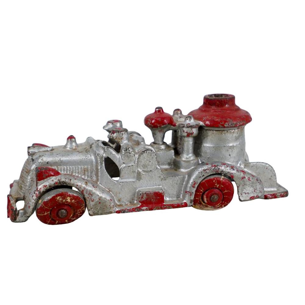 Cast iron toy fire pumper truck with red wheels and a red fire pump on top, shown side view.