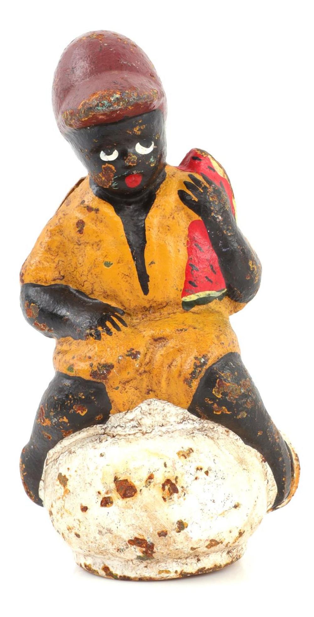 Vintage painted cast iron piggy bank shaped like a man in an orange vest and black suit holding a coin slot on his back.