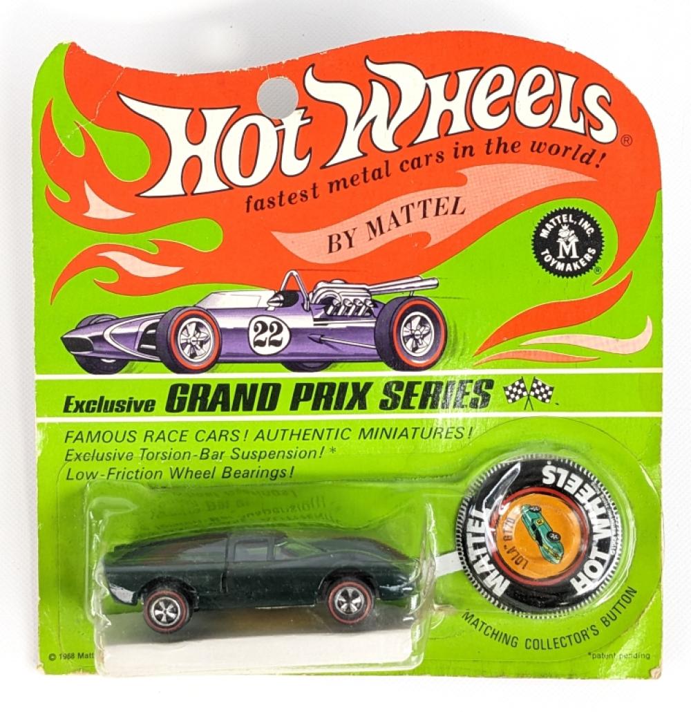 Hot Wheels mini race car in a green blister pack with an orange graphic header and a visible purple race car illustration.