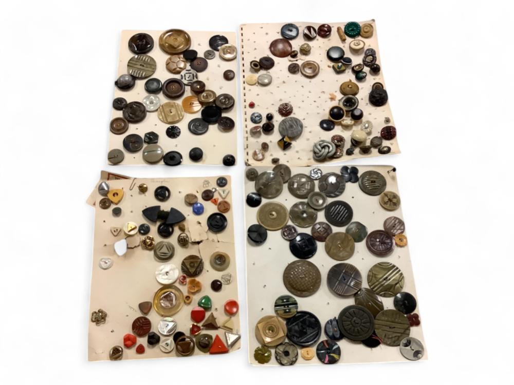 Assorted vintage buttons on two perforated cards, showing many round and shaped designs in black, brown, gold, and other colors.