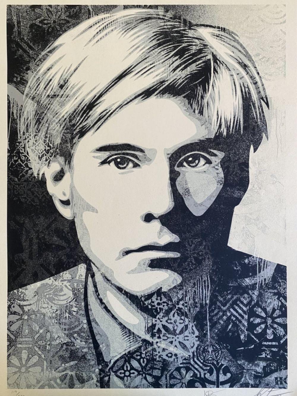 Black-and-white portrait print of a man with spiky hair, shown close-up against a collage of decorative patterns.