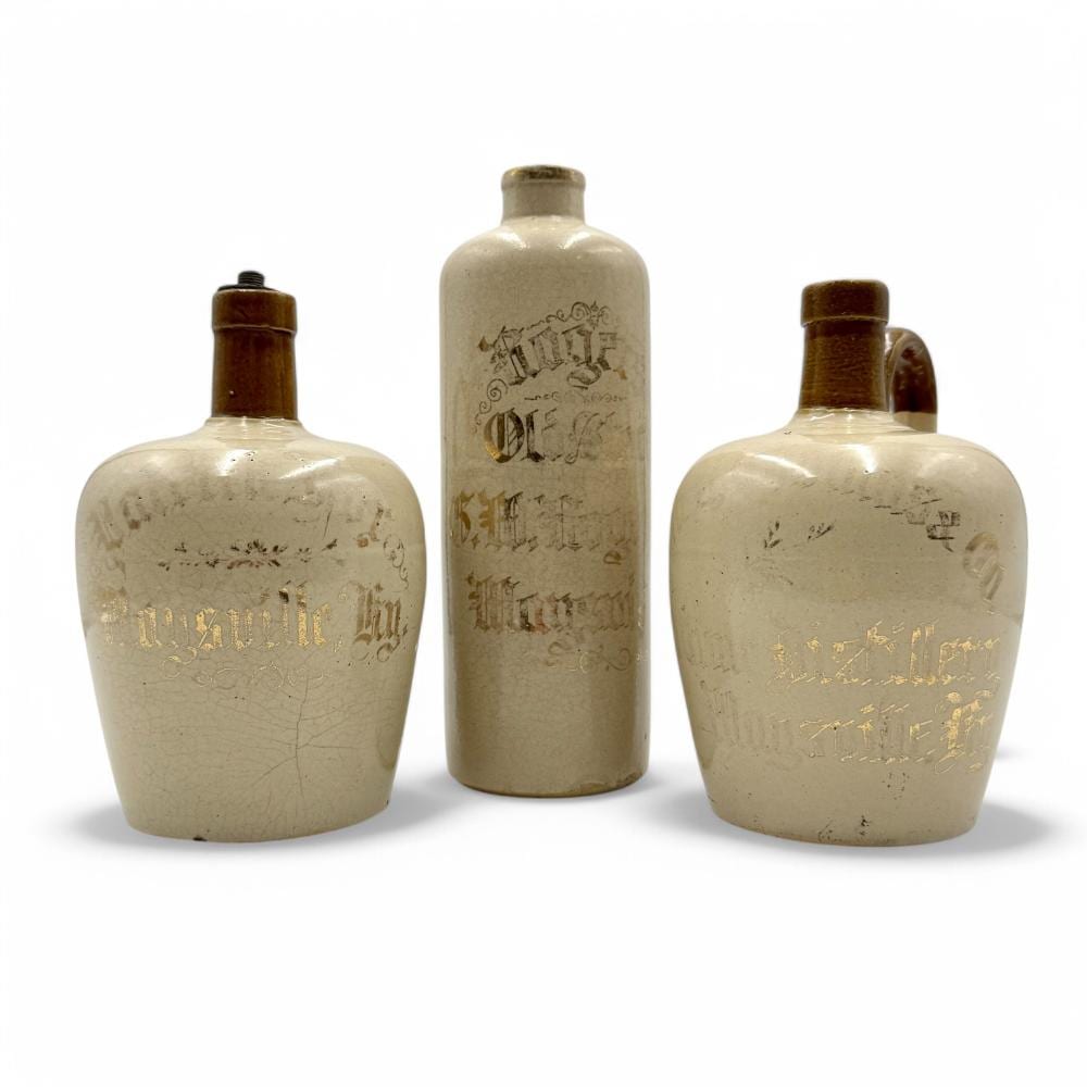 Three Maysville, KY Stoneware Whiskey Jugs sold by Caza Sikes, lot 3 — auction record photograph