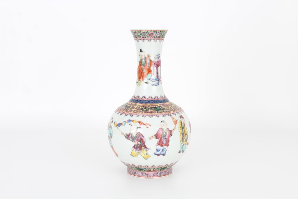 White ceramic vase with a narrow neck and rounded belly, decorated with colorful figures, books, and geometric border patterns.