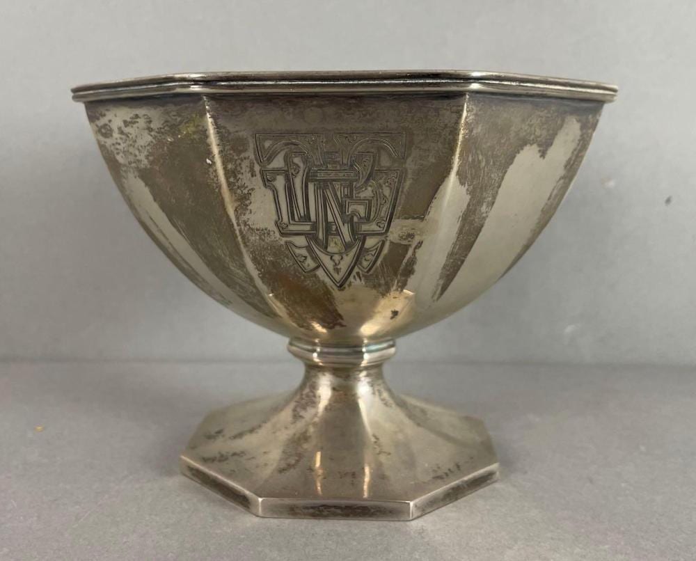 Sterling silver engraved salt cellar cup with a flared rim and shield monogram design.