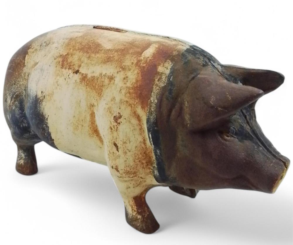 Cast iron pig-shaped piggy bank with a dark brown body and lighter vertical patch on its side, shown on a white background.