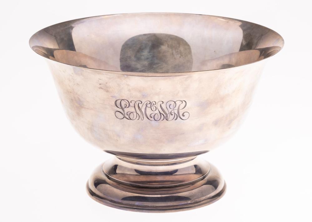 Silver punch bowl with engraved monogram on the front and a flared rim on a circular base.