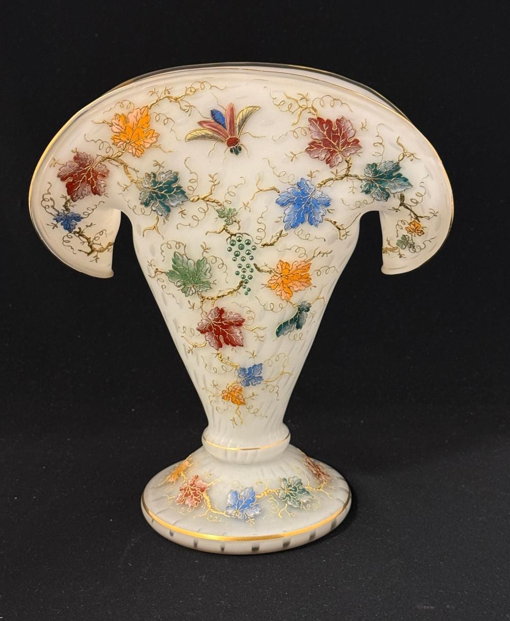 White porcelain vase shaped like a flower pot with a wide flared rim and multicolored floral decoration, including a vertical bead-like center.